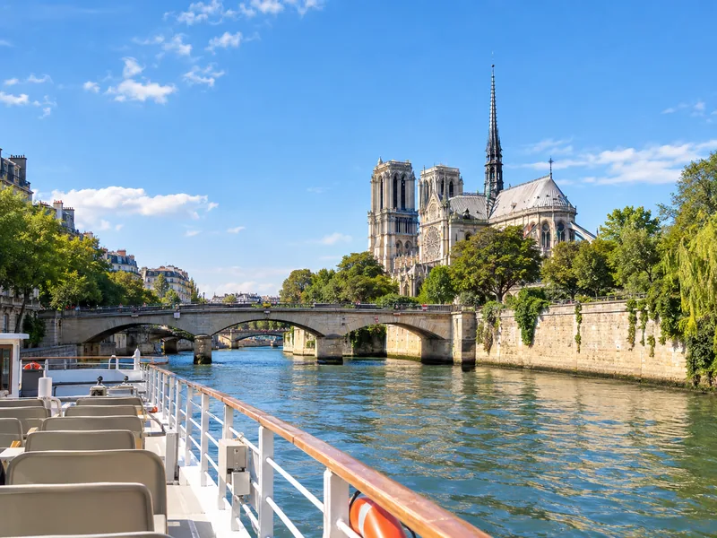 Un bateau de visite sur la Seine longeant des bâtiments en pierre